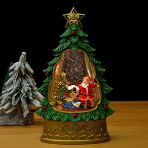 Luminous Christmas tree snow globe music box with Santa Claus on a wooden tabletop
