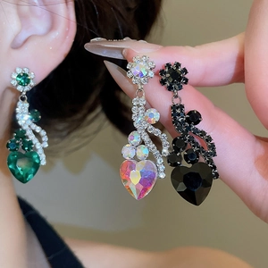 Detailed comparison of flower and heart drop earrings in green, rainbow, and black crystals