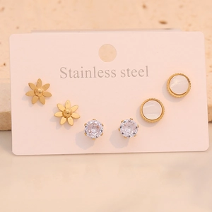 Close-up of a 3-pair stainless steel stud set with flower, zircon, and pearl inlay