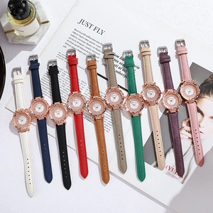 Flat lay of ten colorful women's quartz watches with rhinestone bezel and leather straps