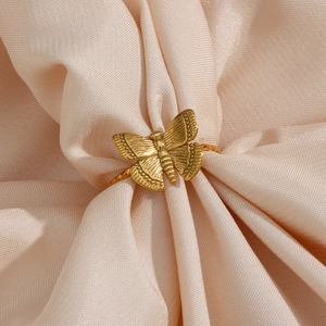 18K gold plated stainless steel butterfly ring on elegant pink silk background
