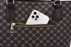 Detailed view of dark brown leather handbag featuring geometric print and phone pocket