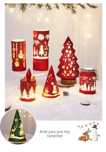 Close-up of festive LED Christmas lamps with reindeer and snowflake patterns on fake snow