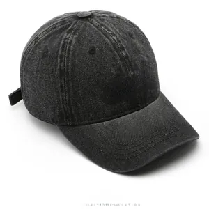 Detailed top view of a dark grey washed denim baseball cap with white BACK embroidery
