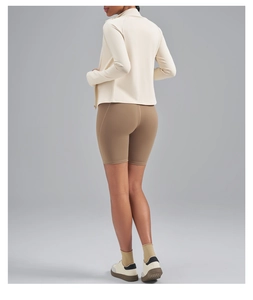 Detail view showing the sleek back fit and matte texture of a slim-fit yoga jacket and shorts