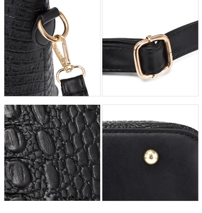 Close-up of black crocodile texture faux leather with premium gold metal hardware details