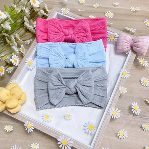 Three-pack of soft knit nylon baby headbands with large bows in pink, blue, and gray colors
