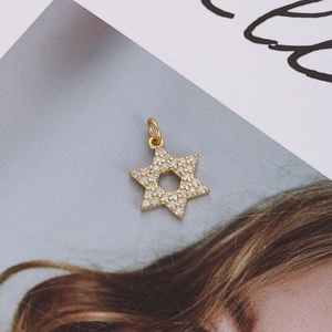 Detailed close-up of 18K gold-plated star pendant with inlaid zircon stones