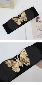 Detail of elegant black elastic waist belt featuring a sparkling golden bow buckle with rhinestones