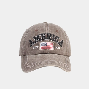 Detailed embroidery of America logo and flag on washed brown vintage baseball cap
