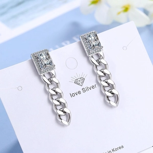 Elegant silver chain earrings with rectangular zircon studs on a blue floral background