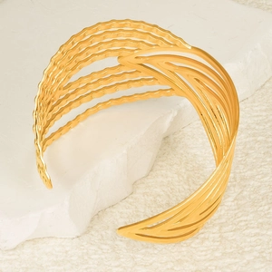 Irregular wide gold-plated stainless steel cuff bracelet with hollow leaf vein design