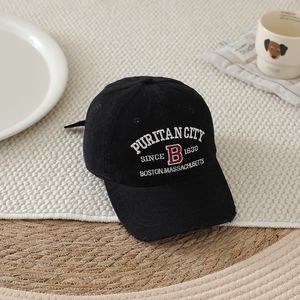Detailed close-up of retro embroidered letter B on a washed cotton boy baseball cap