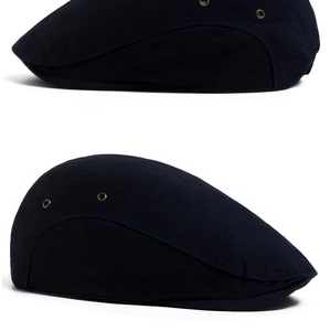 Detail view of cotton newsboy cap featuring metal ventilation eyelets and contrast stitching