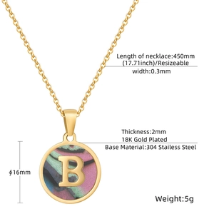 Macro detail of round shell pendant with gold letter B and precise technical dimensions