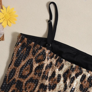 Detailed close-up of leopard print sequin fabric and adjustable black shoulder straps