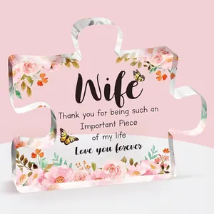 Detail of puzzle-shaped acrylic gift with pink roses and sentimental quote for wife