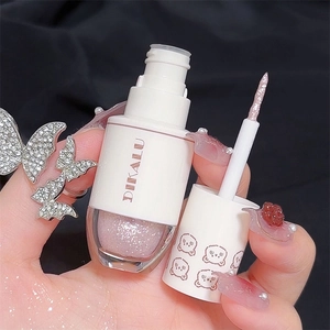 Detailed close-up of pink liquid glitter eyeshadow wand showing sparkly texture and applicator