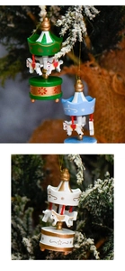 Detailed view of hand-painted wooden carousel Christmas ornaments hanging on a pine tree