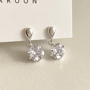 Close-up of S925 sterling silver drop earrings with four-prong set sparkling zircon stones