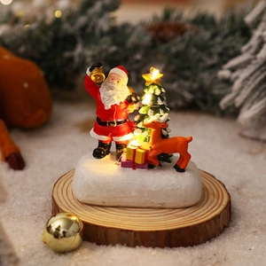 Luminous Christmas scene with Santa Claus and reindeer on a rustic wooden base