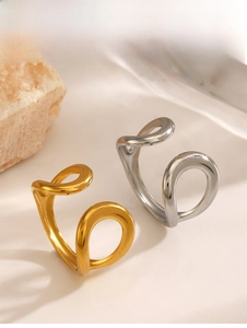 Detailed view of hollow water drop open rings in polished gold and silver finishes