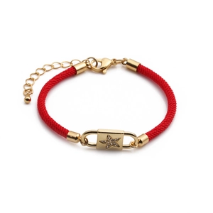 Detail of red braided bracelet with gold star-set lock charm and lobster clasp closure