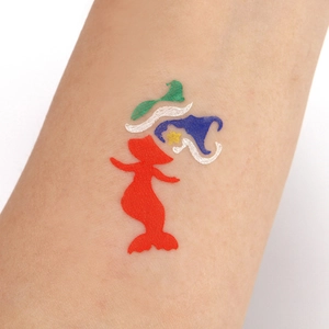 Close-up of a colorful Little Mermaid stencil tattoo sticker on an arm for Halloween party