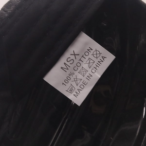 Macro detail of the internal washing label and 100% cotton material on baseball cap