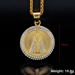 Macro detail of 35mm gold religious medallion with crystals and virgin mary icon