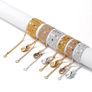 Close-up of DIY jewelry chains in gold and silver finish with lobster clasp closures