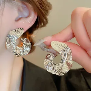 Elegant irregular geometric silver earrings with textured spiral design for women