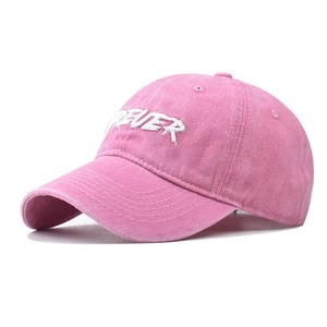 Close-up of Forever embroidery on pink washed cotton baseball cap with retro texture
