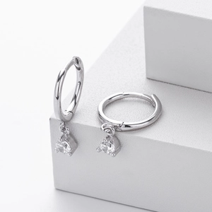 Close-up of 925 silver hoop earrings with a four-prong set round clear zircon stone