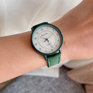 Minimalist quartz wristwatch with dark green leather strap and white numeric dial