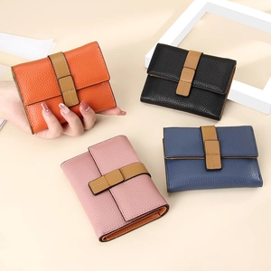 Detailed view of slim leather wallets in orange, black, pink, and blue with RFID protection