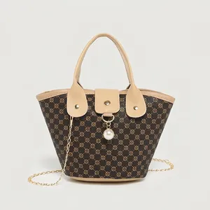 Chic dark brown bucket bag with floral pattern and golden chain strap for women