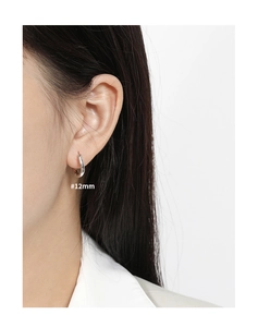 Close-up of 12mm silver S925 sterling silver hoop earring worn on a female model's ear