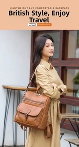 Close-up of brown vintage PU leather backpack with multiple zipper pockets and buckles