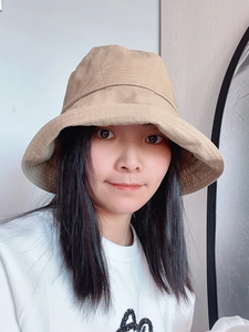 Detail shot of khaki cotton bucket hat with reinforced stitching on the brim