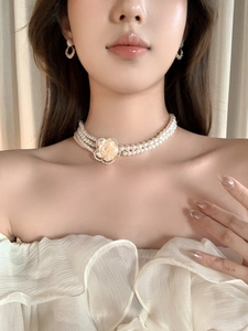 Detailed view of elegant triple-layer resin pearl choker with a diamond rose pendant