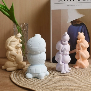 Detail of stacked animal resin ornaments in pastel colors on a wooden table with green plants