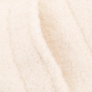 Detailed close-up of soft off-white wool textured fabric for fashion winter coats