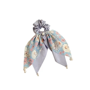 Lavender silk bow hair tie featuring delicate pink floral patterns and a pearl pendant