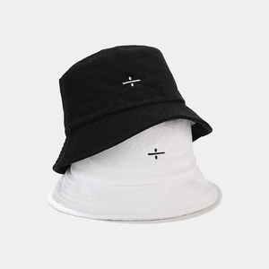 Terry cloth bucket hat set in black and white featuring minimalist symbol embroidery