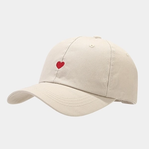 Minimalist cream cotton baseball cap featuring a small red heart embroidery detail