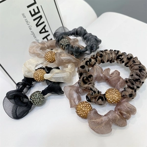 Elastic mesh scrunchies with sparkling rhinestone balls in leopard and solid colors