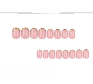 Detail view of mini short French press-on nail kit with pink base and metallic gold tips