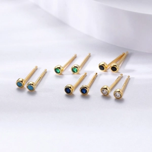 Detail of round colorful zircon stud earrings set with s925 silver needles and gold finish