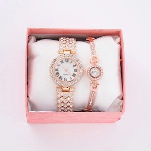Detailed view of rose gold quartz watch and diamond bracelet set in a pink gift box